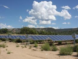 Solar panels under a partially-clouded sky in Colorado.