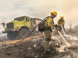 Two firefighters mopping up spot fires