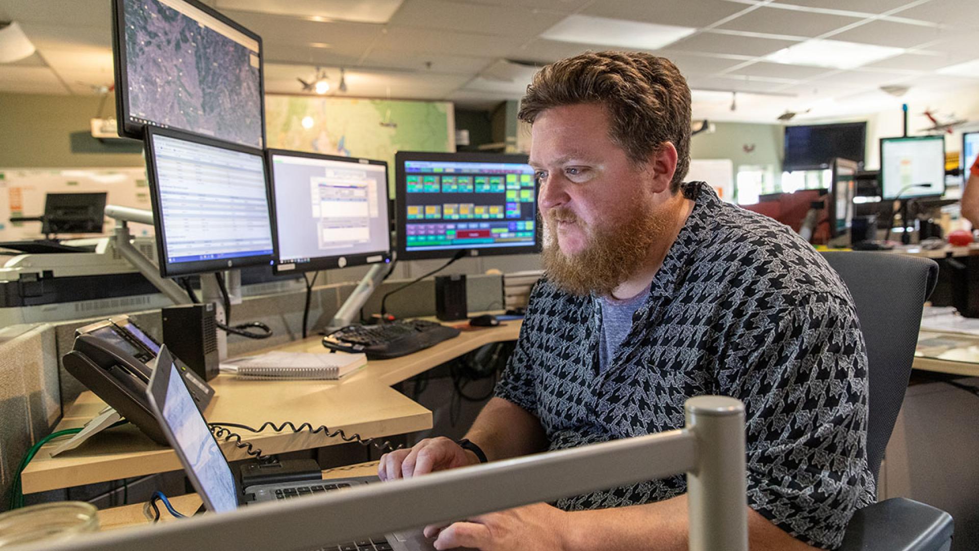 A dispatcher at the Boise Interagency Dispatch Center tracks wildfires and firefighting resources in southwestern Idaho. Photo by Neal Herbert, Department of the Interior.