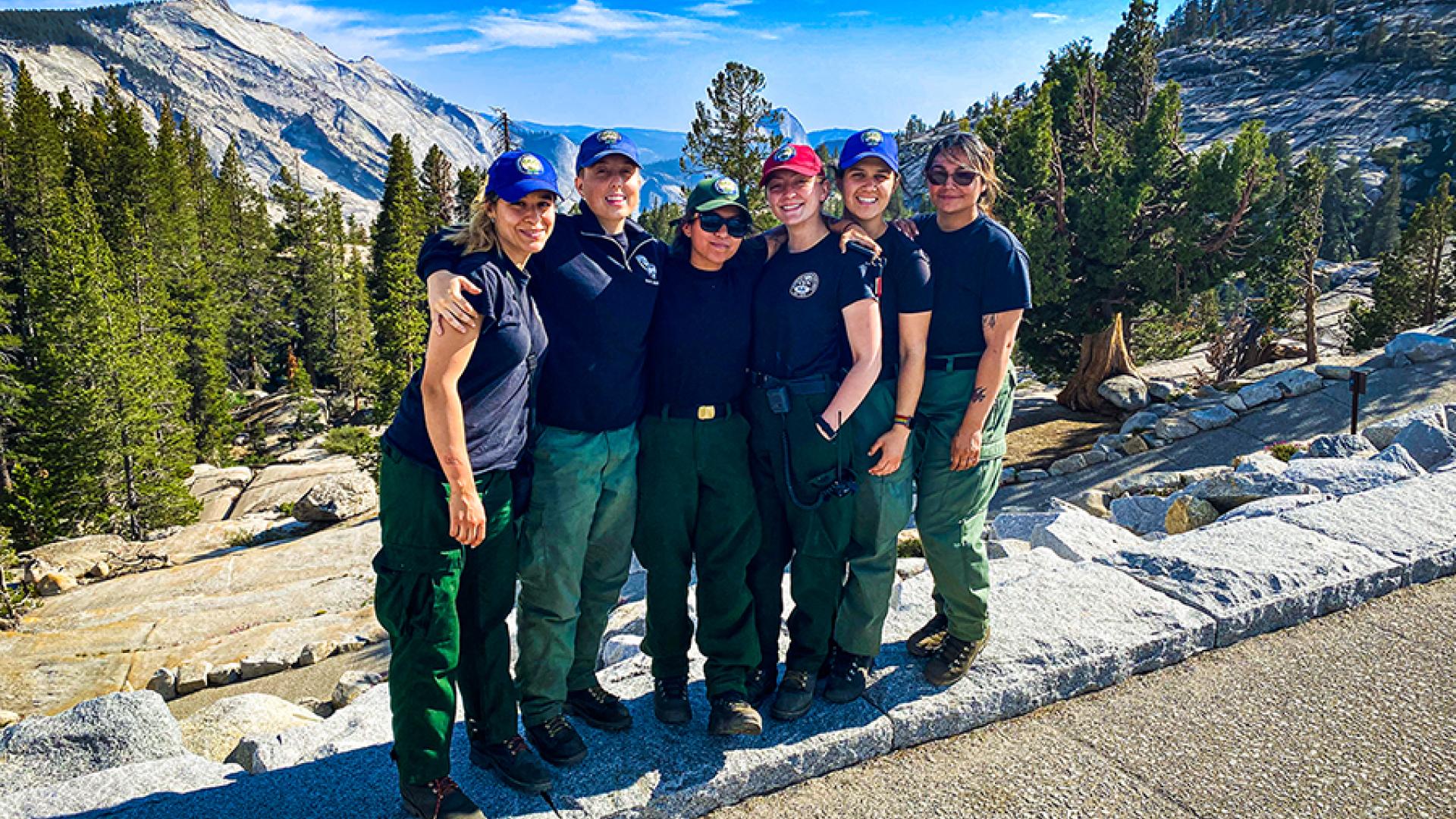 Six members of the all-women conservation corps fire crew at Yosemite National Park pose for a photo at a park viewpoint. (Photo by NPS.)