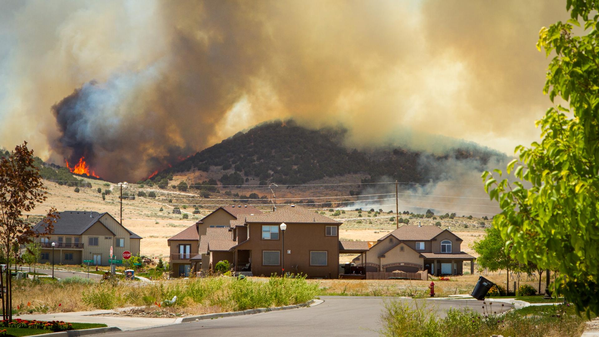 A wildfire burns near a community.