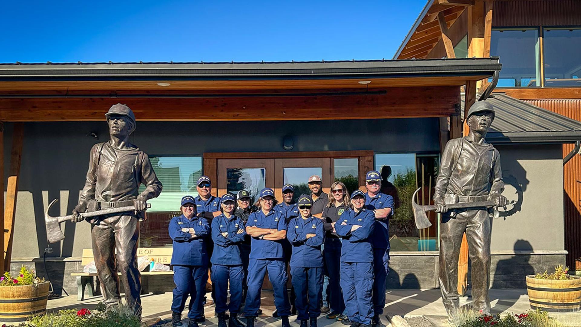 Behavioral Health Officers serving wildland fire personnel with the Interior and Agriculture departments stand at the entrance to the National Interagency Fire Center in Boise, Idaho.