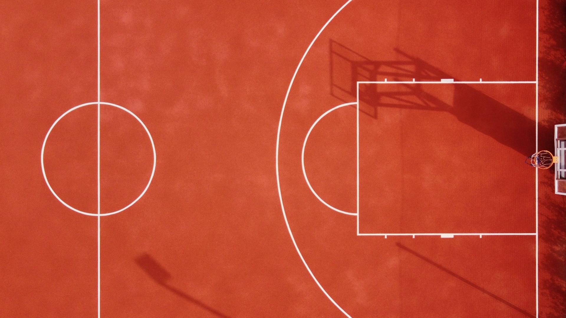 Photo of orange and white basketball court