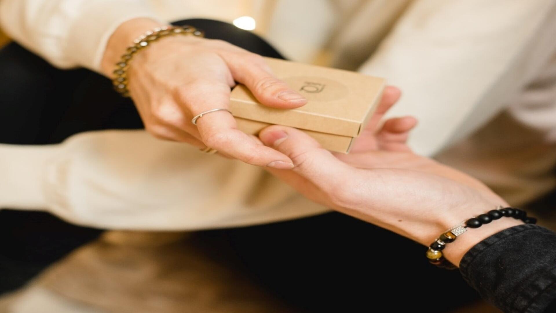 Two hands exchanging a gift