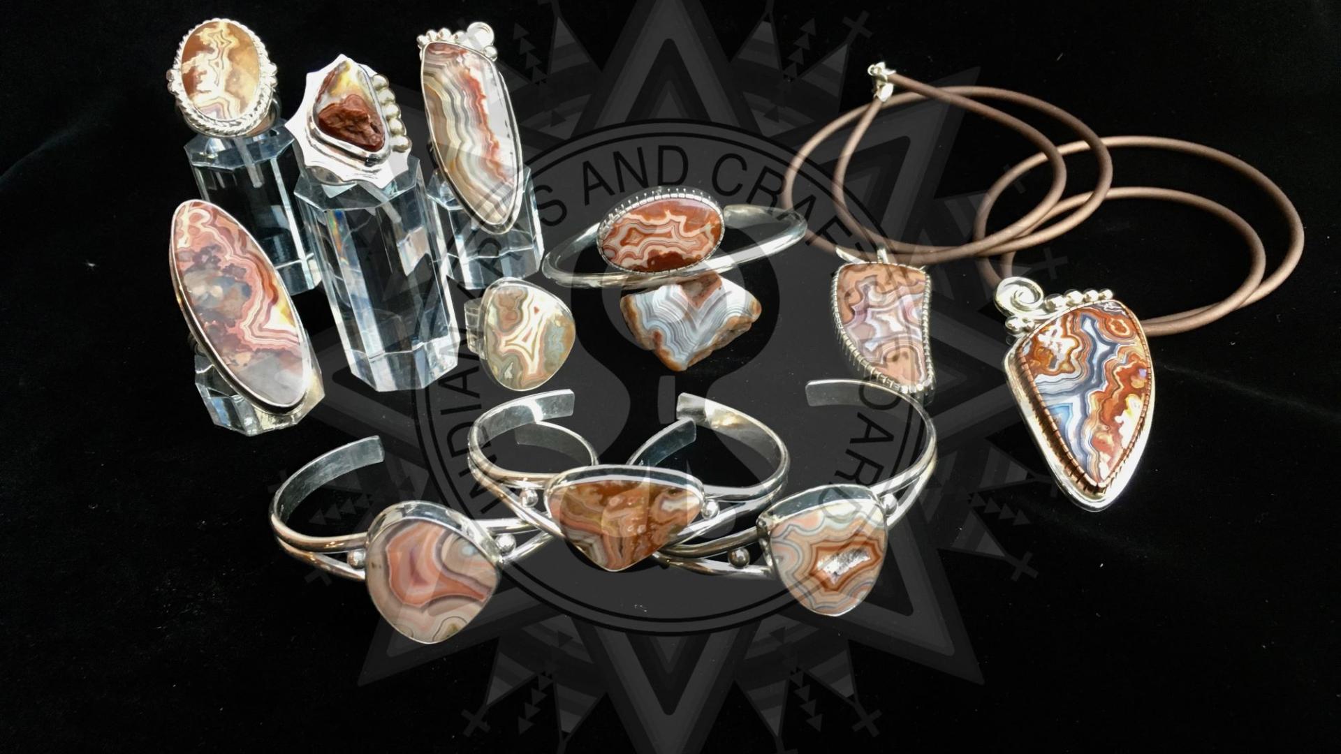 Photograph of silver and agate bracelets and other jewelry.