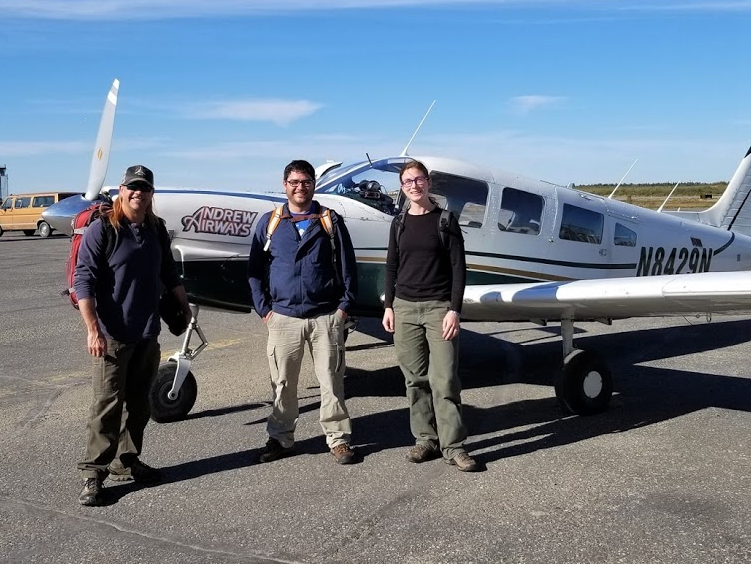 AVSO staff members in Alaska, including two graduates of the apprentice program. Three people standing in front of a small plane