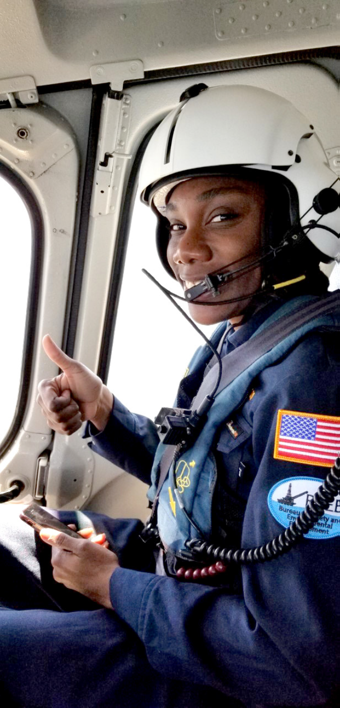 Ramona wearing a helmet and uniform gives a thumbs up to the camera.