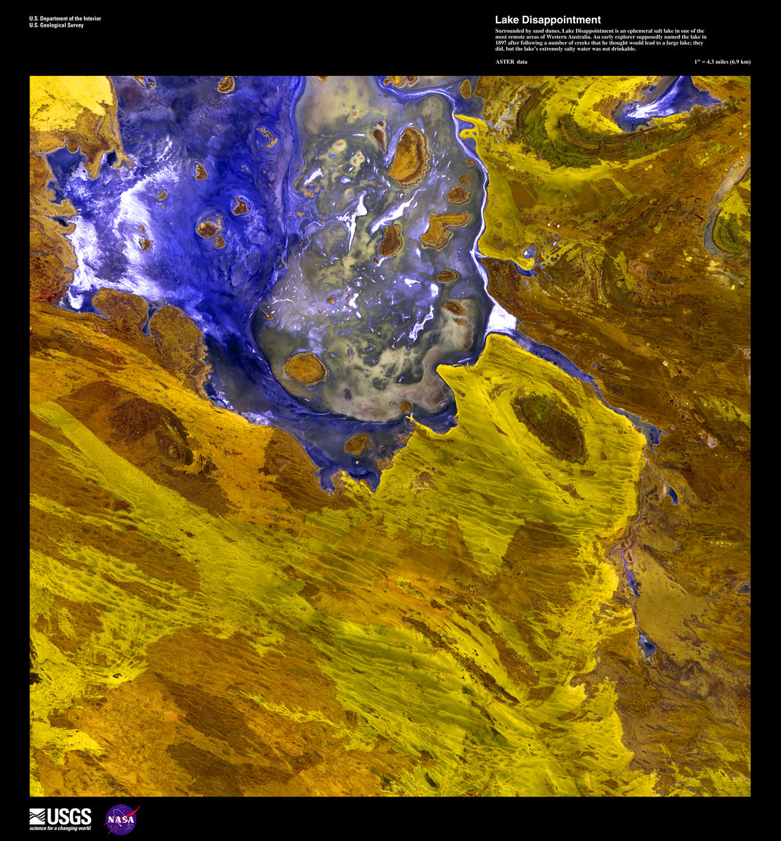 Landsat imagery showing a bright, dark blue lake surrounded by shades of gold.