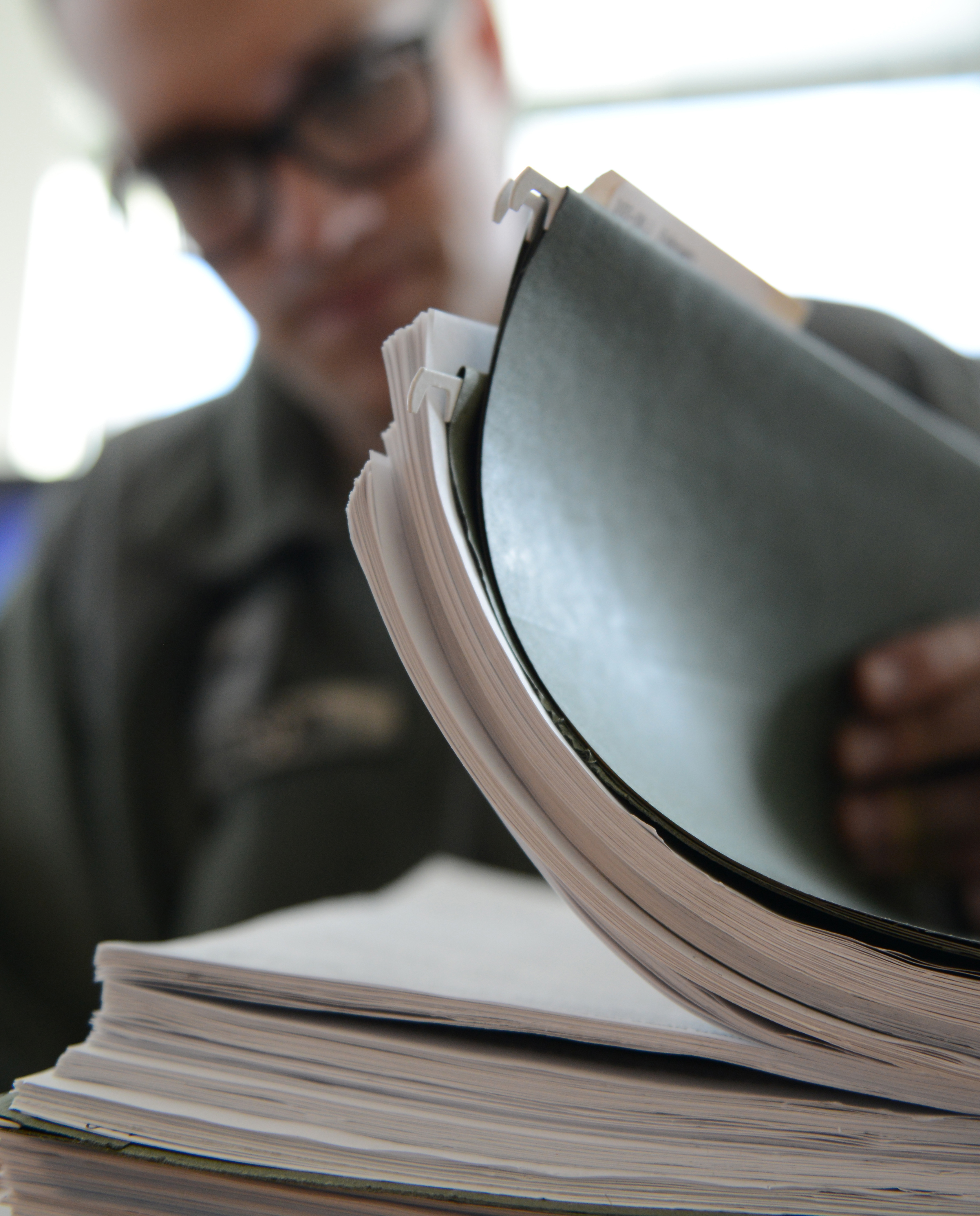 Employee looking through a folder of papers.