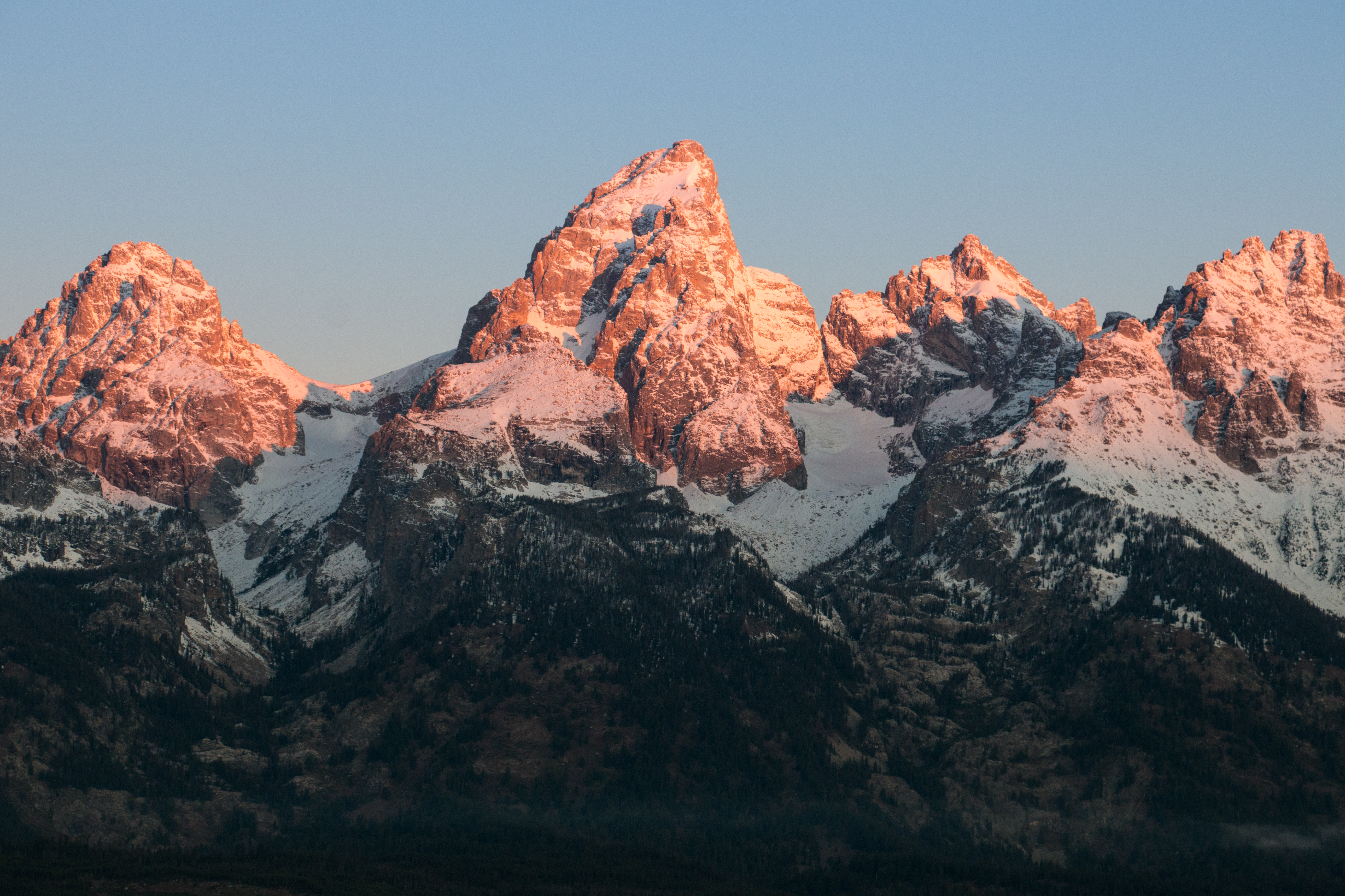 The sunrise morning light hits the mountain peaks.