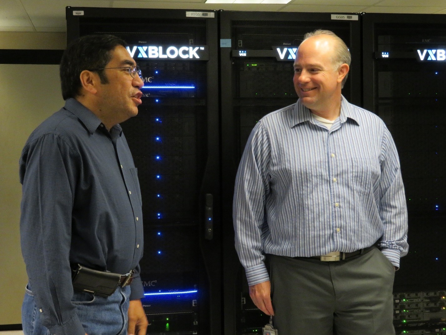 Justin Wade and a colleague talk in the server room. 