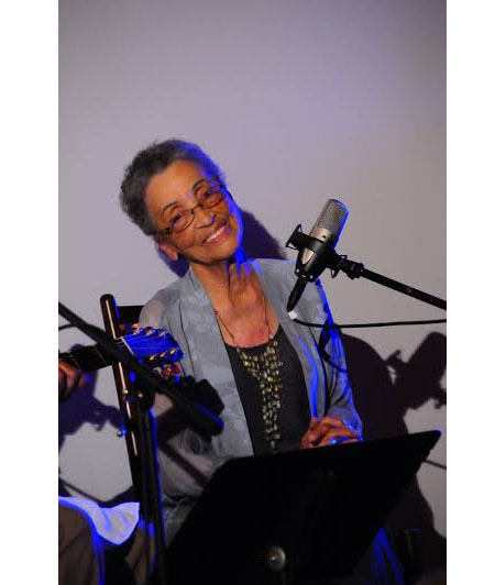 Photo of Betty Reid Soskins singing at a benefit concert on her 90th birthday