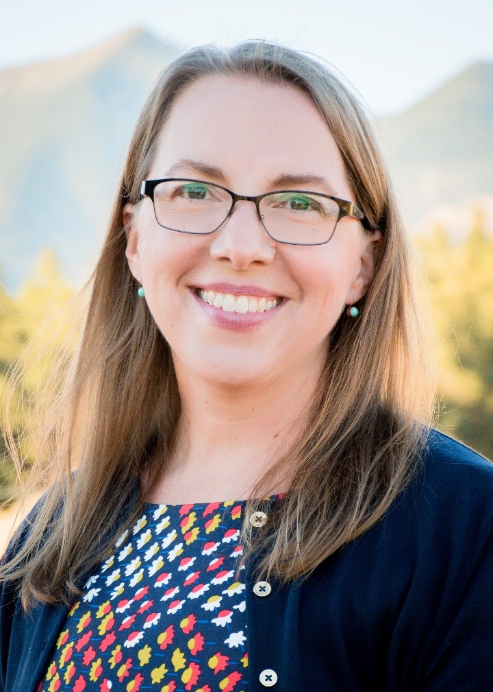 Portrait of Robin Fergason with mountains in the background.