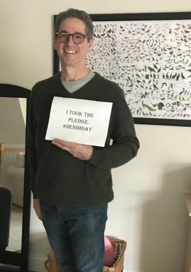 Ron Begin from FWS holding the I Took the Pledge #DenimDay sign