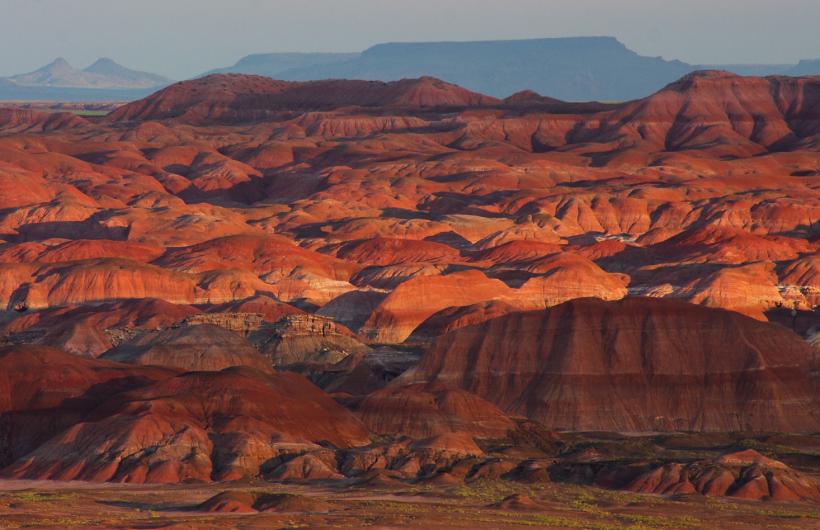 Multi-colored hills glow in the setting sun