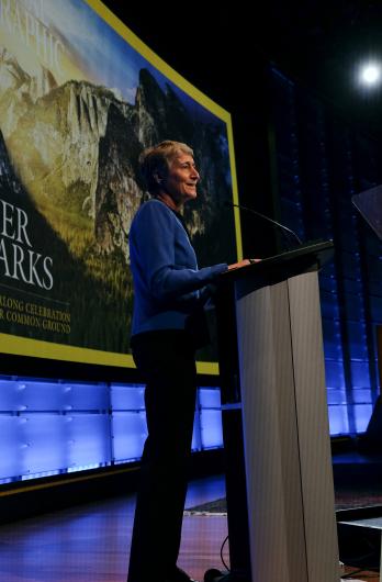 Secretary Jewell stands at a lectern, speaking.