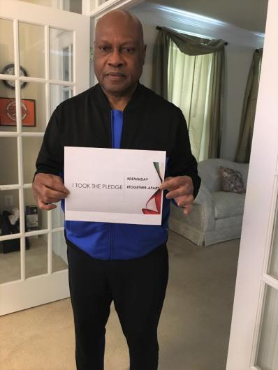 Alvin Dillings from OCR holding the I took the Pledge #DenimDay sign. 