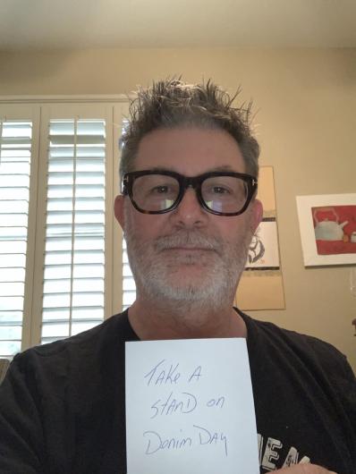 Jamie Bowen from USBR holding the I took the Pledge #DenimDay sign.