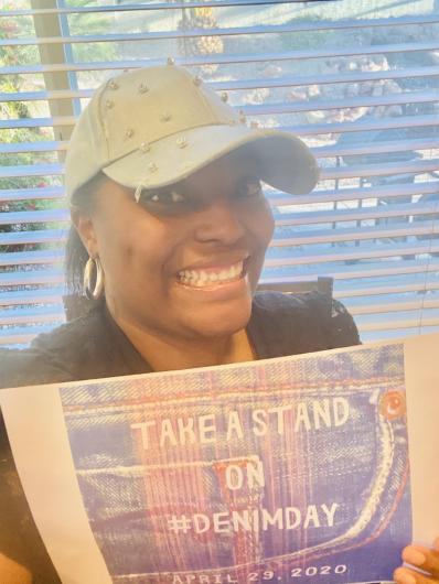 Britanny Johnson from (USBR) holding the I took the Pledge #DenimDay sign.