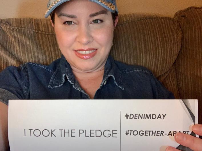 Brittany McAleese from USBR holding the I took the Pledge #DenimDay sign. 