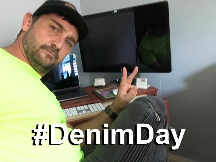 Carl Smith from USGS sitting next to computer #Denim Day written on image.