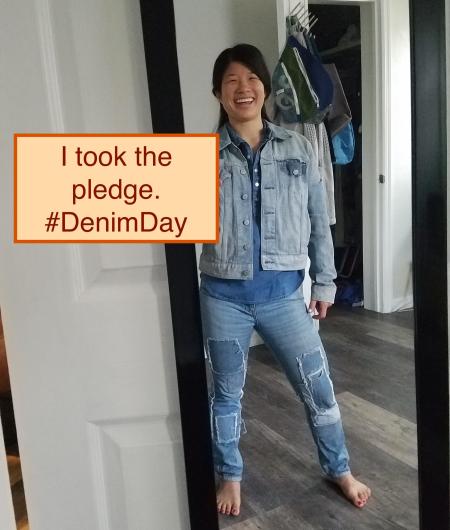 Emily Wei from USGS, dressing in denim jacket and jeans next the I took the Pledge #DenimDay sign. 