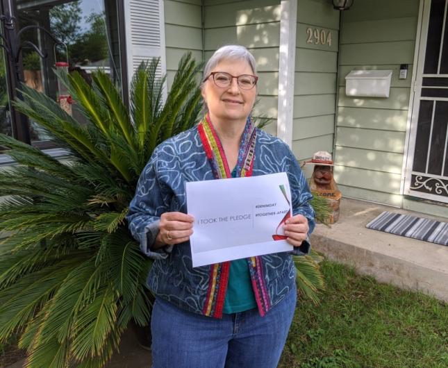 Genievieve Rasmussen from BLM, outside the I took the Pledge #DenimDay sign.