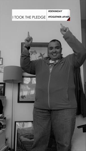 Kim Gray from BLM holding the I took the Pledge #DenimDay sign.