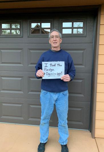 Grayford Payne from USBR holding the I took the Pledge #DenimDay sign.