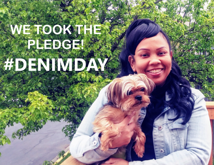 Kim Olivier from DOI outside, holding a dog words I took the Pledge #DenimDay written on the photo image. 