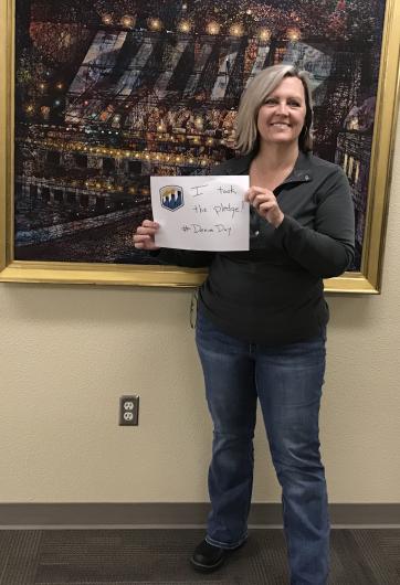 Lorri Gray from USBR holding the I took the Pledge #DenimDay sign
