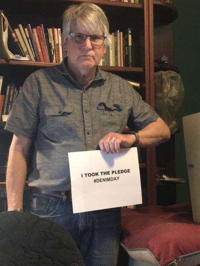 Mike Diggles from USGS holding the I took the Pledge #DenimDay sign. 