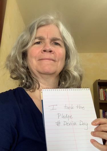 Mary Riddle from NPS holding the I took the Pledge #DenimDay sign. 