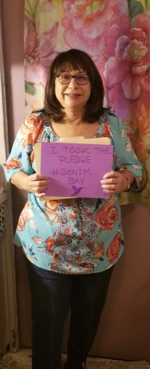 Paulette Reyes from FWS holding the I Took the Pledge #DenimDay sign