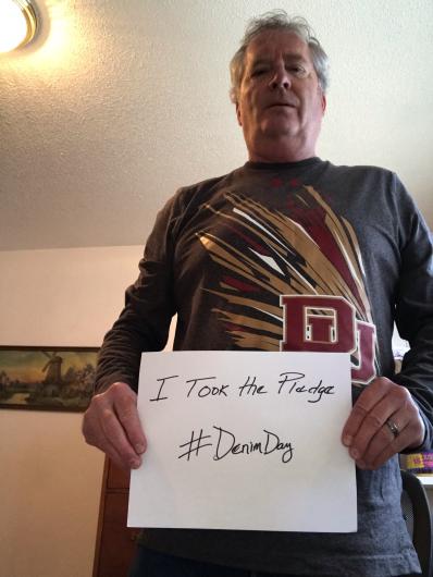 Robert Pike from USBR holding the I took the Pledge #DenimDay sign. 
