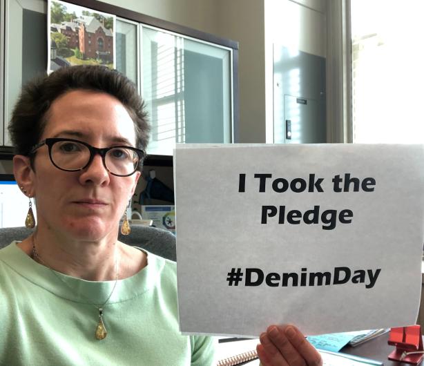 Rachel Fisk from DOI holding the I took the Pledge #DenimDay sign. 