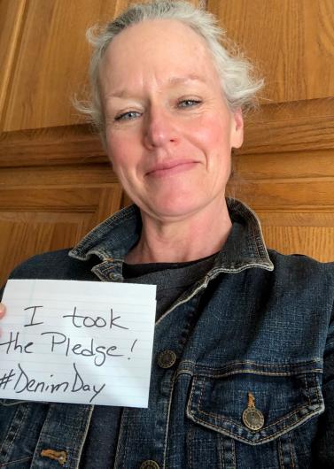 Ruth Welch from USBR holding the I took the Pledge #DenimDay sign.