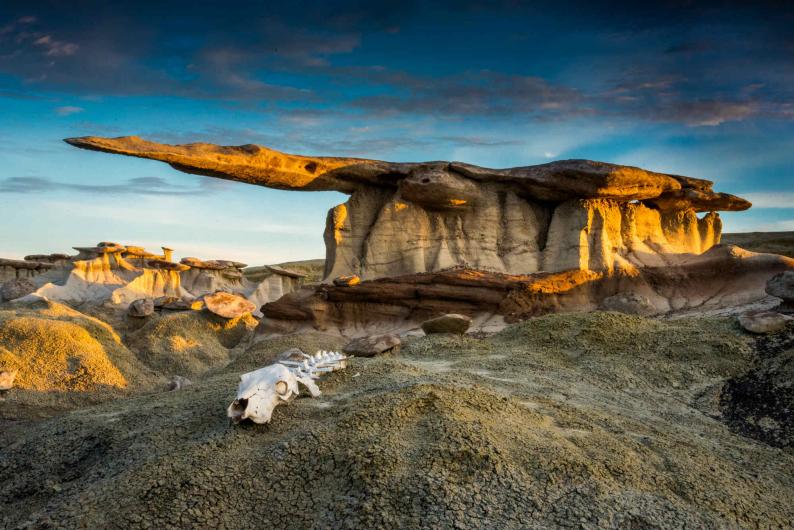 A strange and jagged rock formation jutting out of the desert floor.
