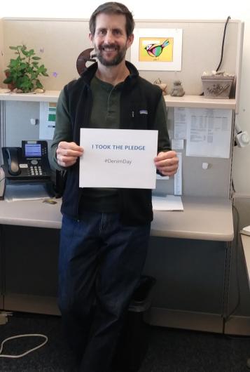 Ted Struzeski from USGS holding the I Took The Pledge #DenimDay sign