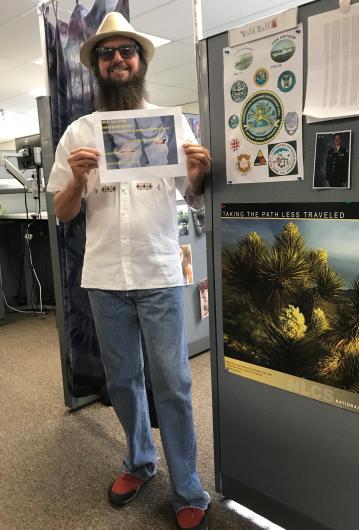 William Civish from BLM holding the I took the Pledge #DenimDay sign. 