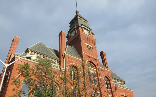 A large, ornate red brick building with a clock tower at Pullman National Monument.