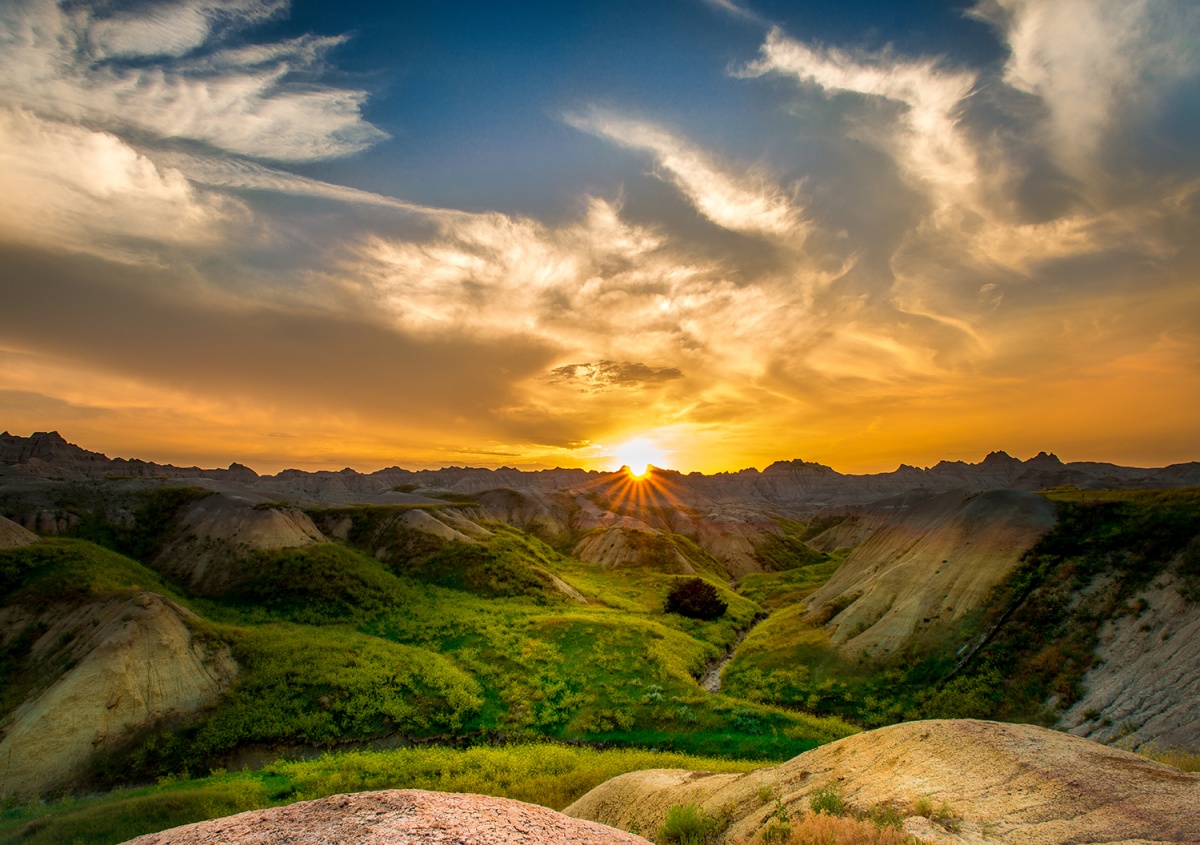 Sunset over green prairie at Badlands National Park.