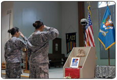 Two 29th Infantry Brigade Combat Team Soldiers pay their final respects to Spc. Cwislyn K. Walter by saluting one last time. Walter, 19, of Honolulu, Hawaii, died as a result of injuries sustained in a single vehicle accident in Kuwait, on Feb. 19. 