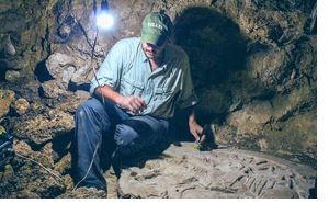 Archaeologist Dr. Marcello Canuto, Director of the Middle American Research Institute at Tulane University and Co-Director of the La Corona Project, sits beside the ancient Maya altar that he and his colleagues discovered in the jungles of northern Guatemala. (Image credit: National Museum of Archaeology and Ethnology in Guatemala City / La Corona Regional Archaeological Project.)