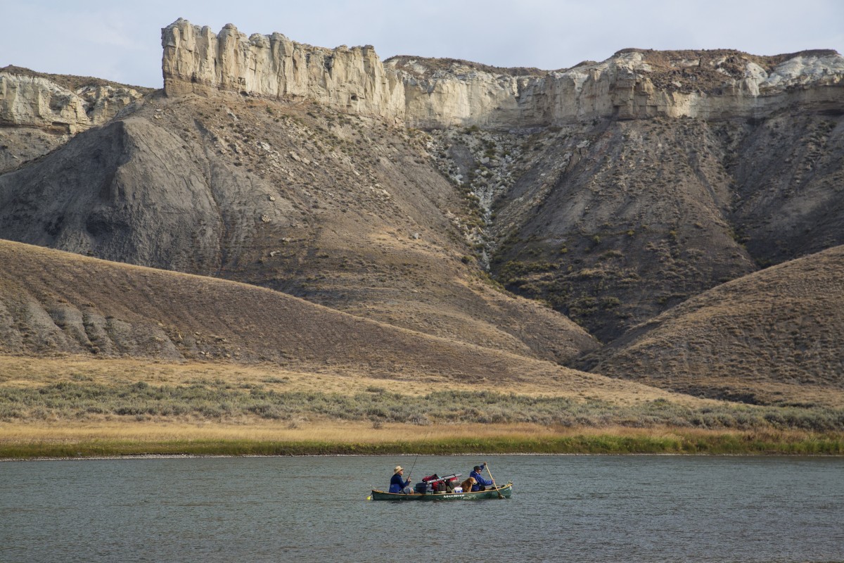 Anglers paddle a boat on the Missouri Wild and Scenic River.