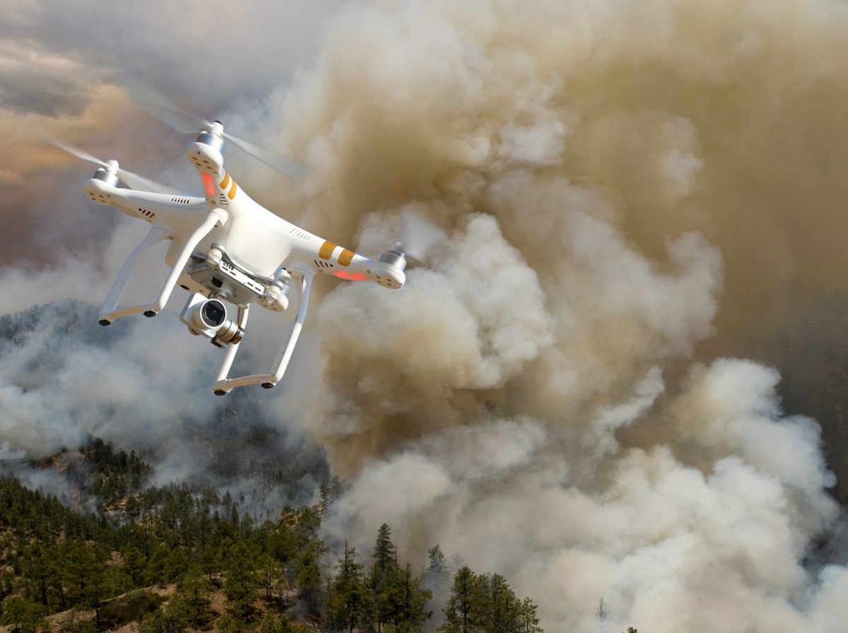 A BLM wildfire drone flies over a blanket of smoke.