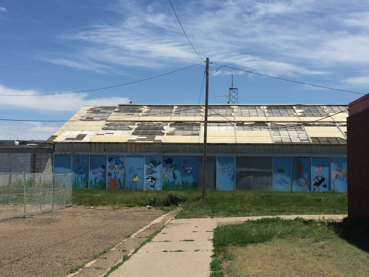 A long building with a damaged roof.