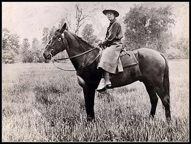 Clare Marie Hodges sits on horseback in dress.