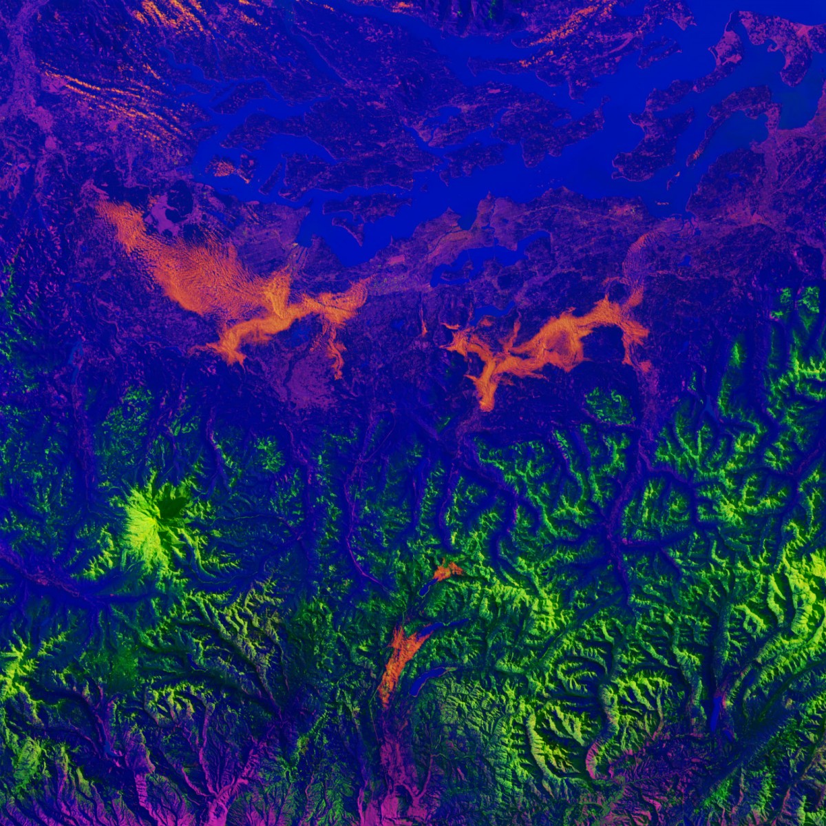 A satellite photo of a blue plain dotted with pink swirls and green jagged lines.
