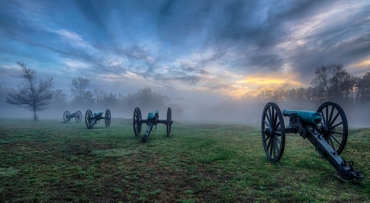 green grass, cannons, fog